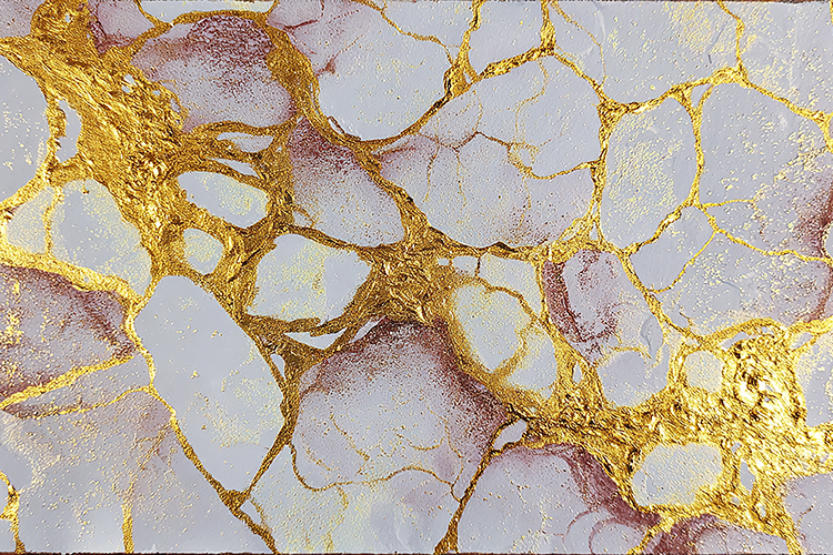 A marble surface with gold veins and white and purple hues