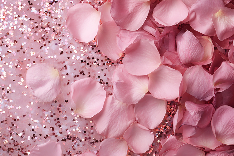 Pink rose petals and glitter on a soft background
