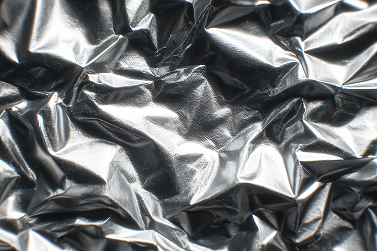 Crumpled silver foil with a shiny reflective surface
