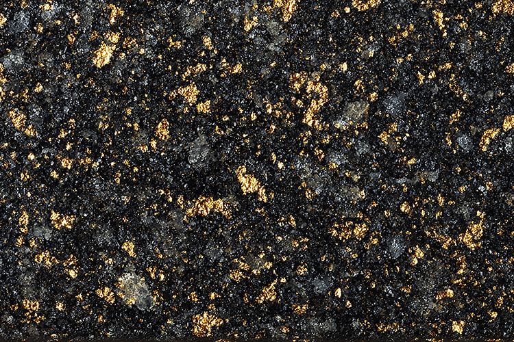 A close-up view of a dark granite surface with gold flecks