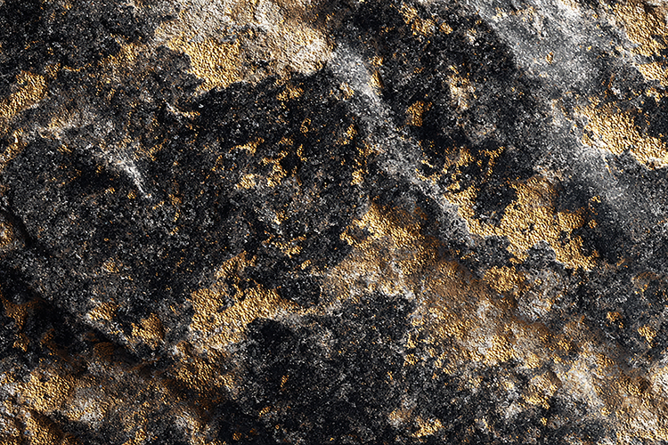 A textured rock surface with black, gold,and gray colors
