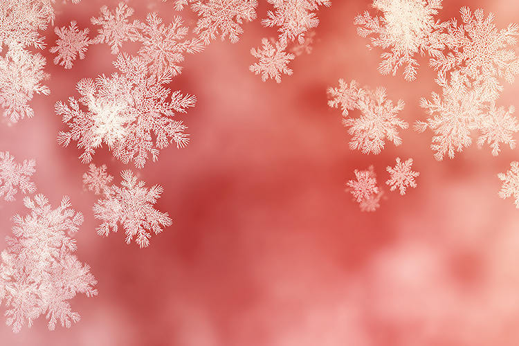 A delicate display of white snowflakes on a soft pink