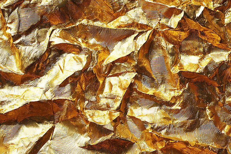 A crumpled gold foil with a textured surface