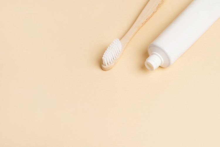 Blank white tube of toothpaste and wood brush on (2716600)