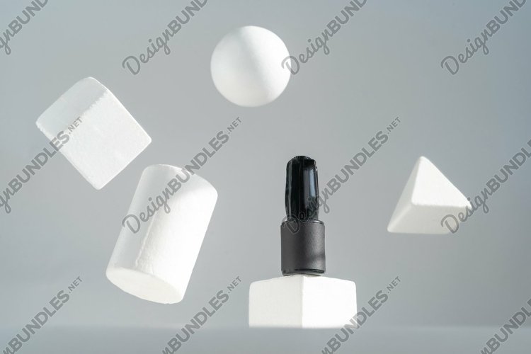 A black bottle stands on a white pedestal, geometric shapes example image 1