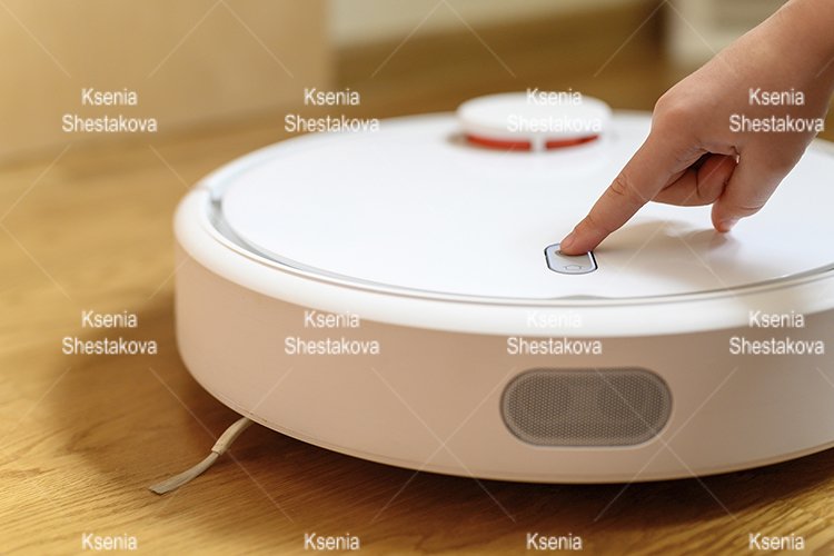 kids hand press button to turn the robot vacuum cleaner on example image 1