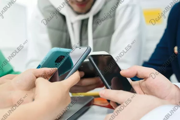 Multiethnic people use smartphones in the office, close up