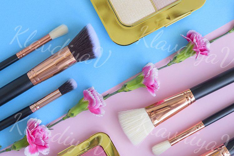 premium makeup brushes and blush on a colored background