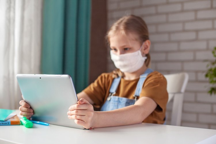 Girl in a medical mask. Distance Learning, Online Education