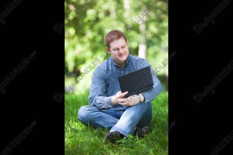 Businessman working in the park. example image 1