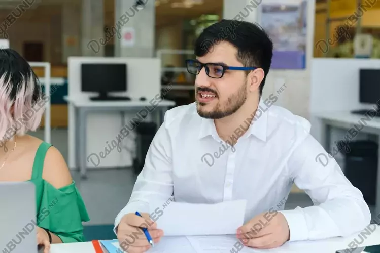 Arabic man offers business solutions at a meeting.