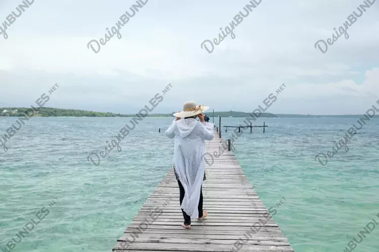 Woman walking on wooden dock