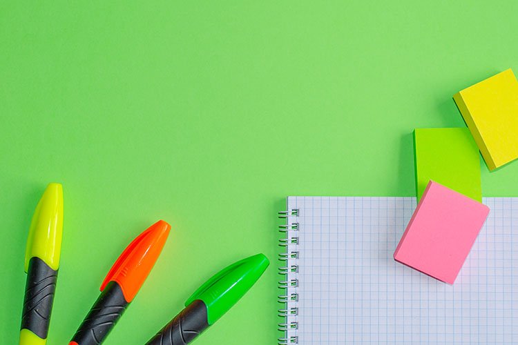 School and office supplies on office table, green background