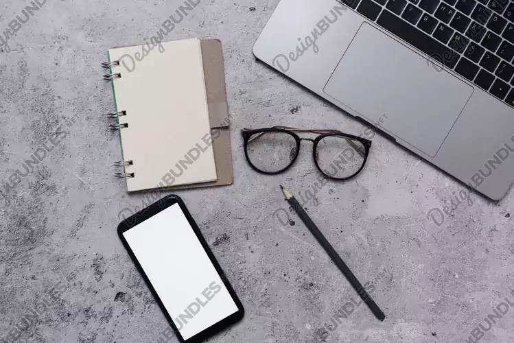 Mock up phone in modern office with laptop, notepad