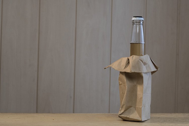 Glass bottle with a cider on the table example image 1