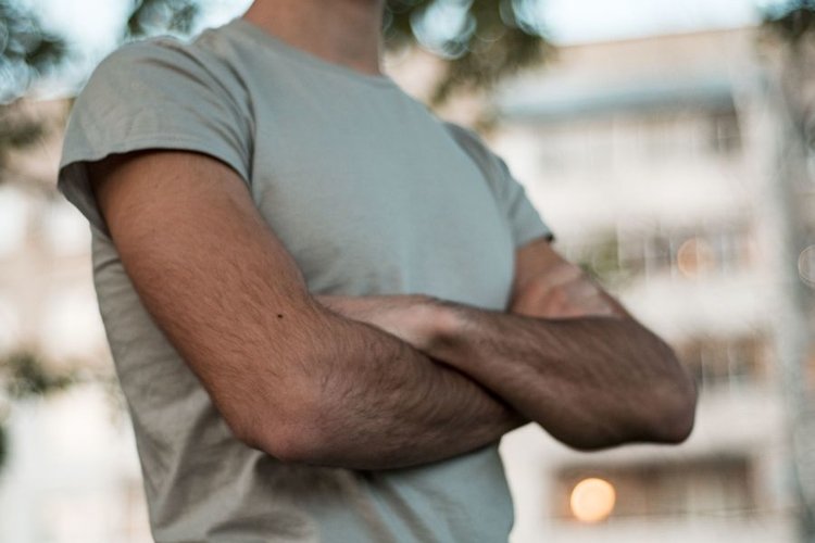 Young caucasian man walks in a park example image 1