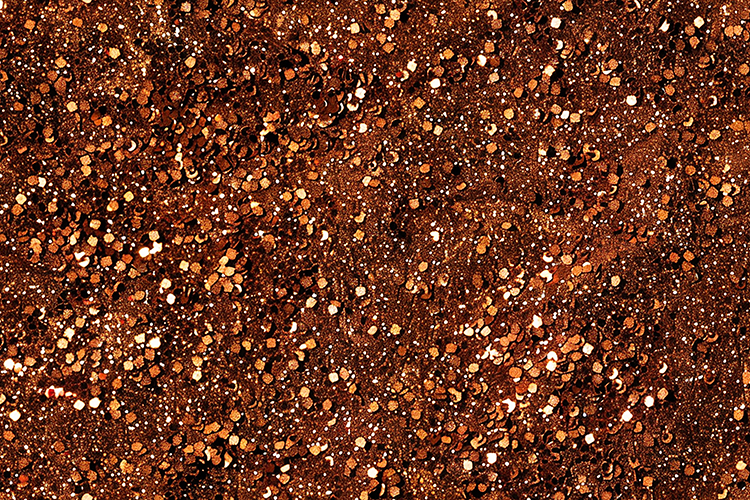 Brown glittery surface with small shiny particles