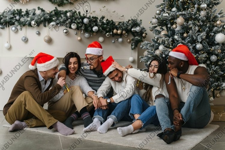 Friends at the Christmas tree are fooling around