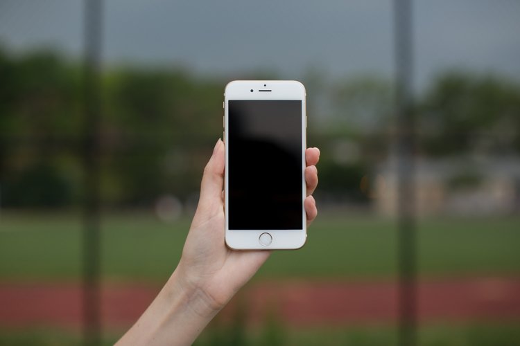 Female hand holding smartphone  example image 1