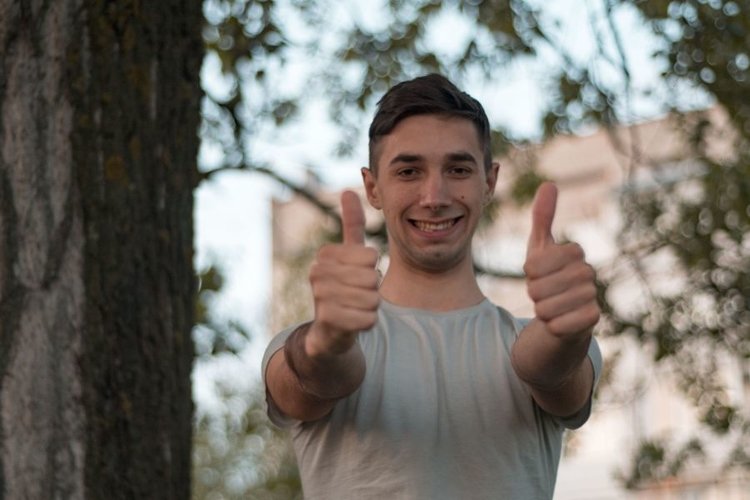 Young caucasian man walks in a park