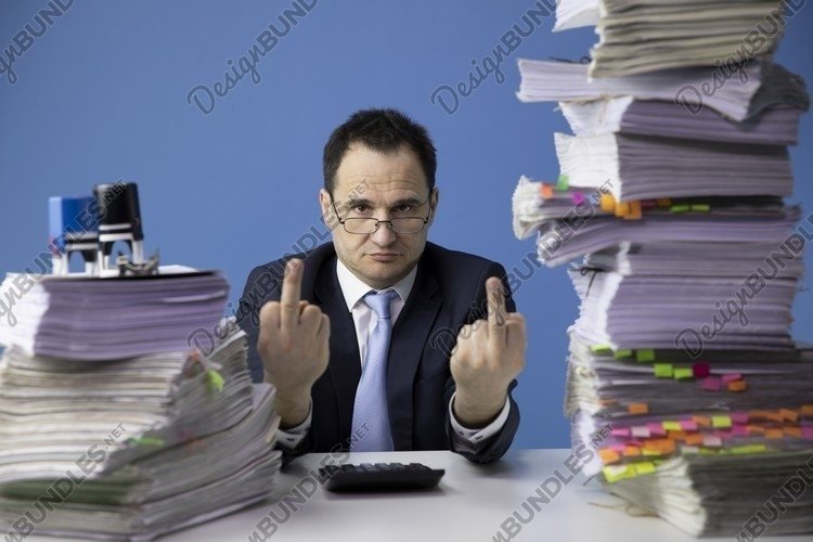 businessman sitting at office desk with stack of documents example image 1