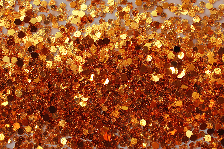 Golden and orange confetti on a gray background