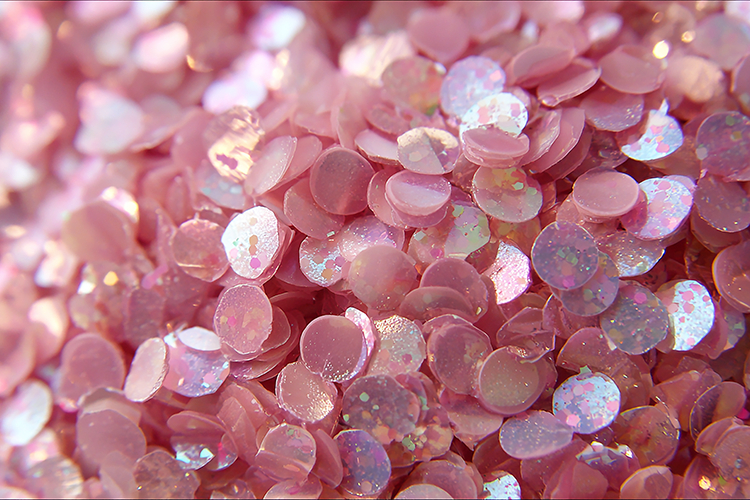 Pile of shiny pink sequins with iridescent glitter