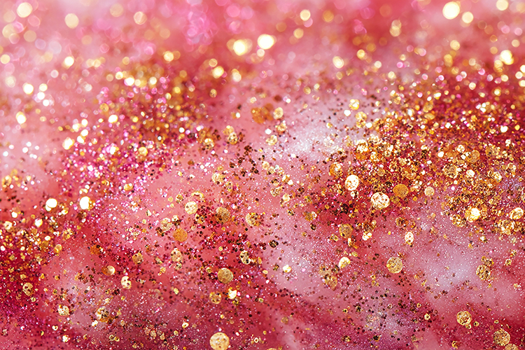 Pink and gold glittery background with sparkling particles