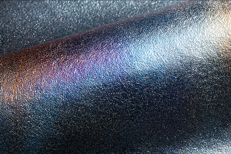 Shiny, metallic surface with a textured, iridescent finish