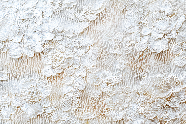 White lace fabric with intricate floral patterns and designs