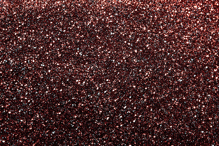 A dark red glittery background with small white specks