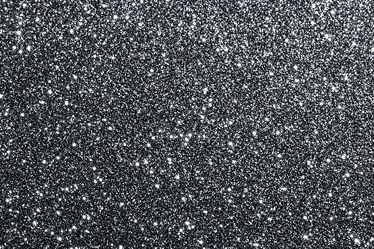 Black surface covered with white specks and dots