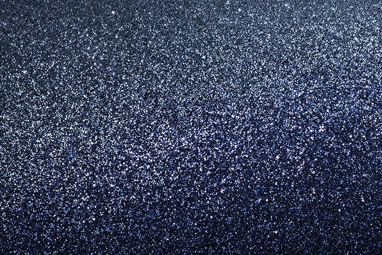 A dark blue glittery background with sparkling white specks
