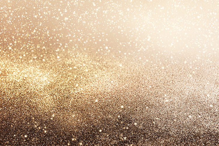 A sparkling gold glitter background with a gradient of light