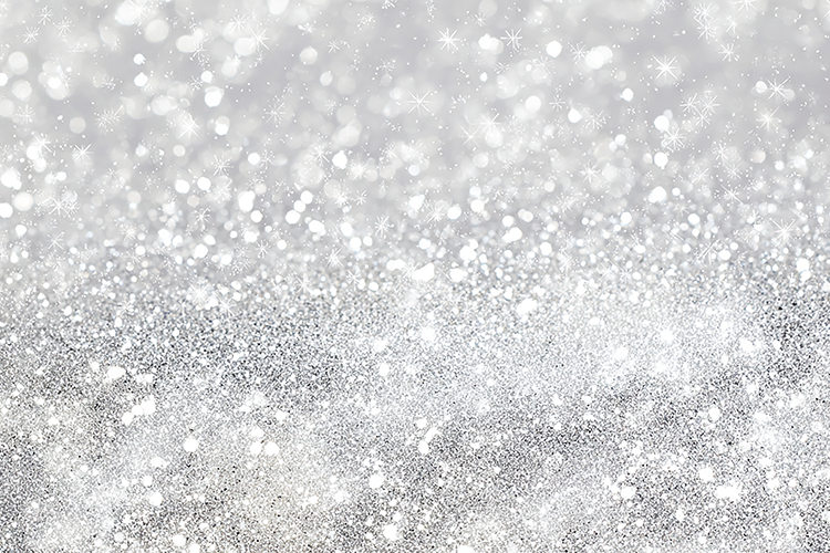 A sparkling silver glitter background with white specks