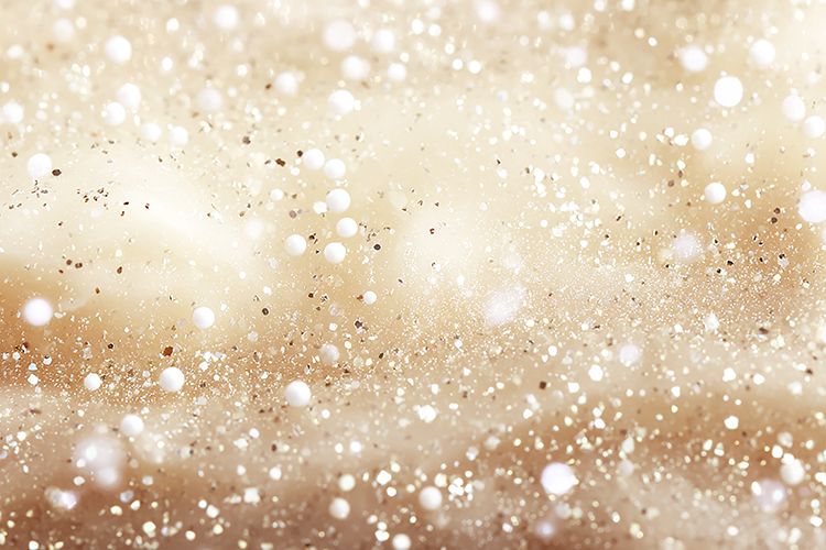 A sparkling gold background with white dots and glitter