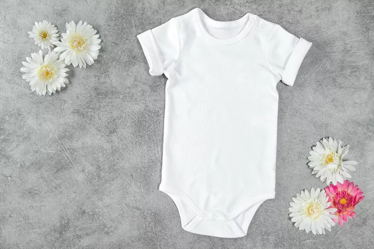 White baby bodysuit mock up flowers stock photo