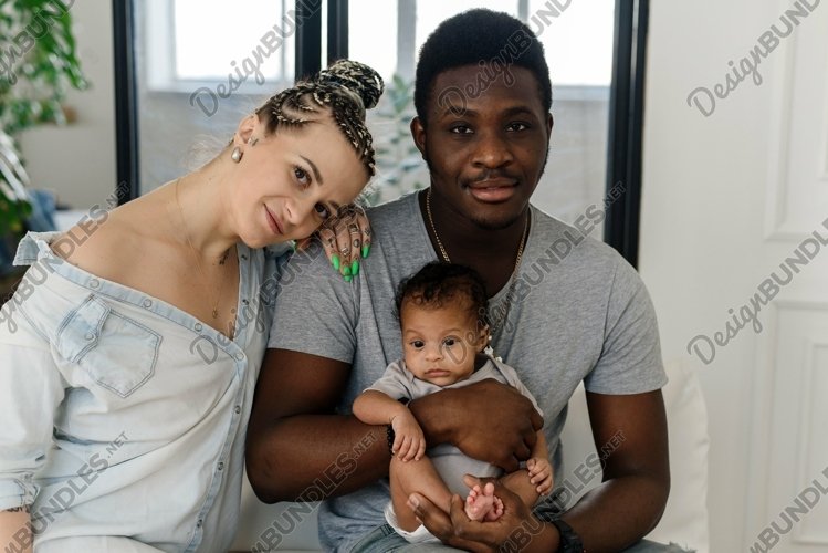 Close-up image of a cheerful family with a little boy example image 1