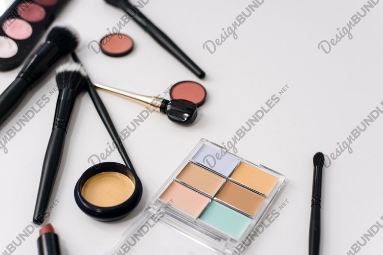 Eye shadow, makeup brushes, concealer and shadows on white example image 1
