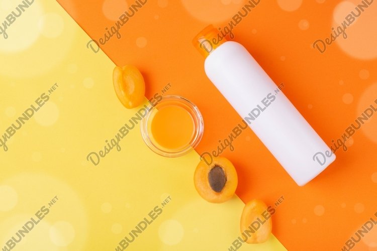 Shower gel with apricot on orange and yellow. JPG photo