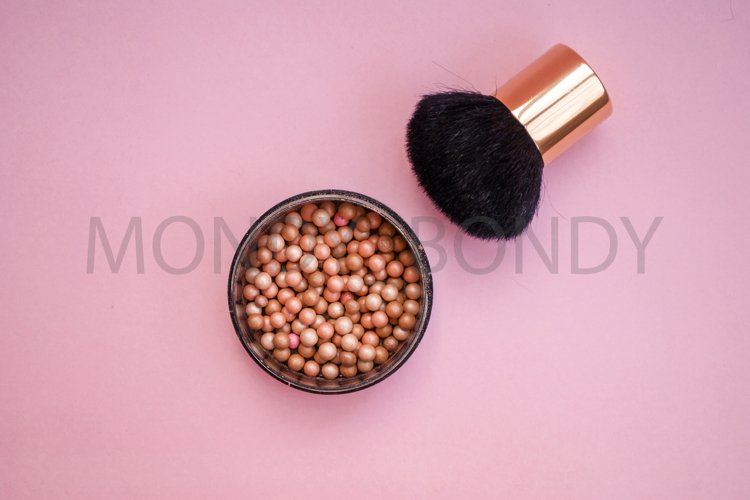 Cosmetic blush in spheres on a pink background. example image 1