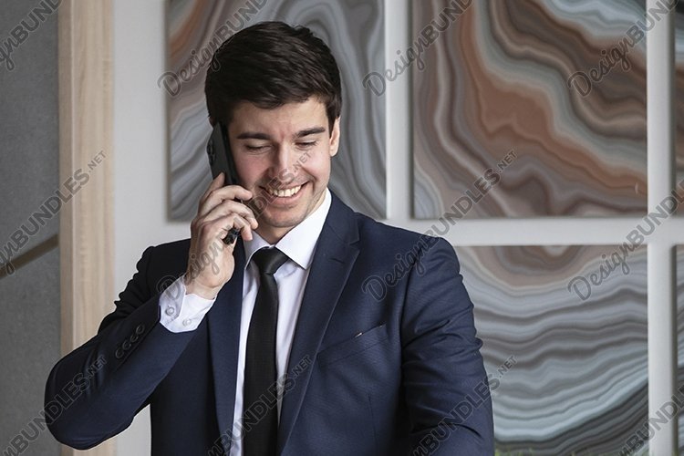 portrait of a businessman in a dark blue suit in the office