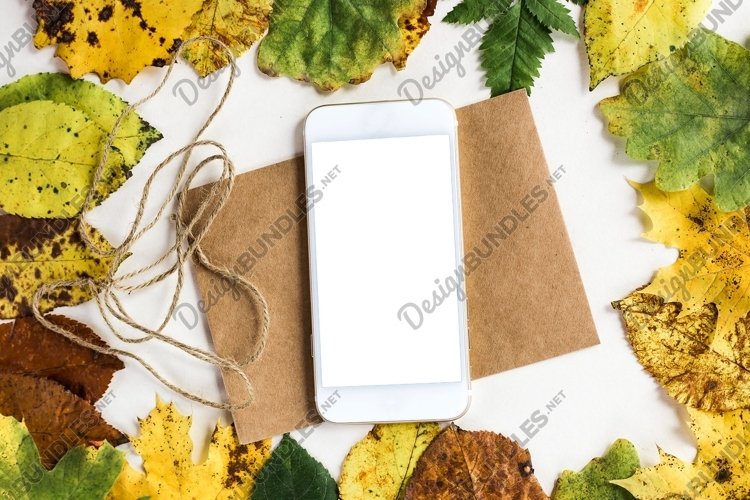 mobile lies on a postcard in autumn leaves example image 1