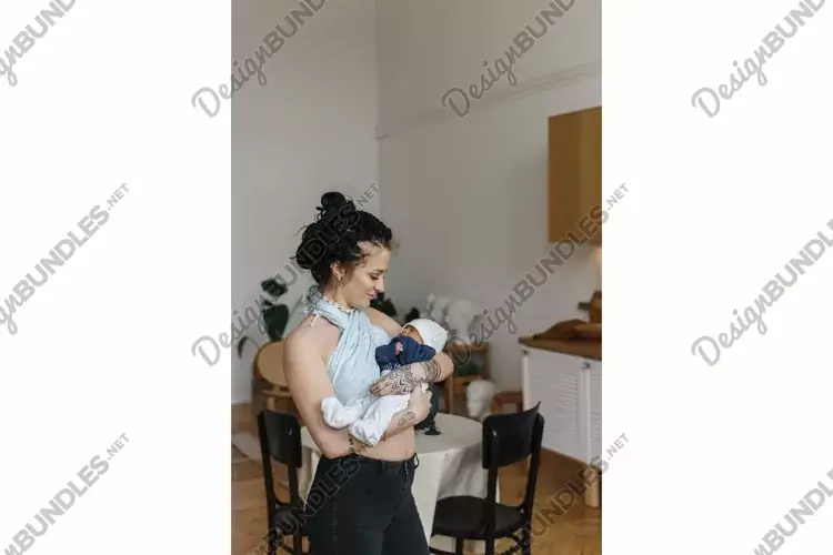 Caucasian woman cradles her African-American mestizo baby.