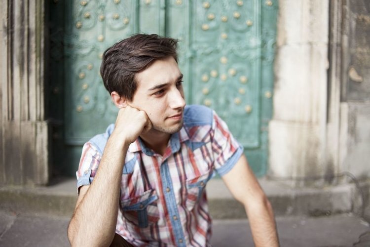 Young man walks in the city example image 1