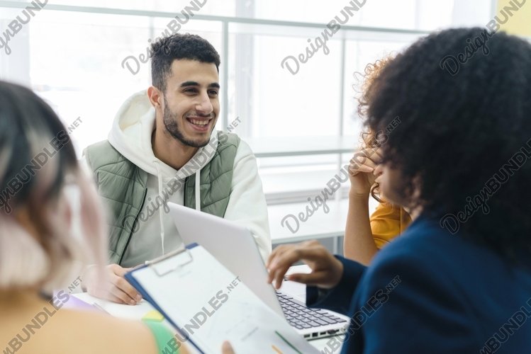 Portrait of an Arab employee talking with colleagues. example image 1