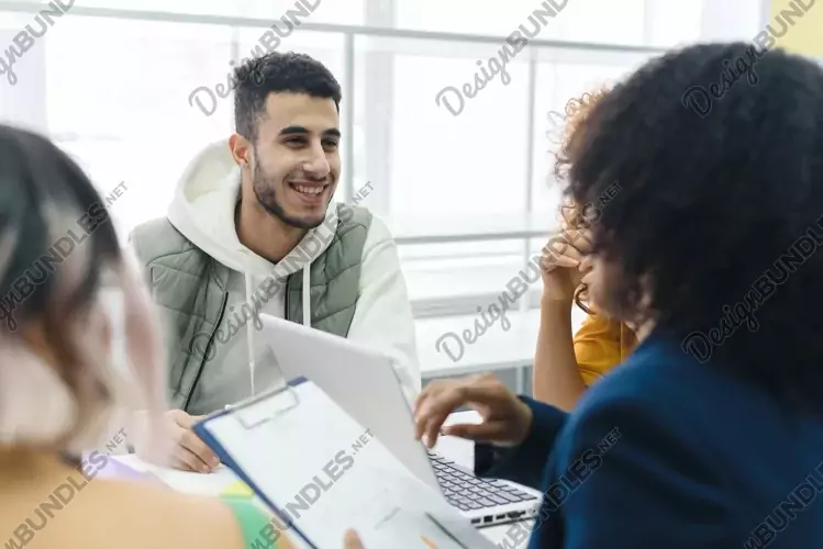 Portrait of an Arab employee talking with colleagues.