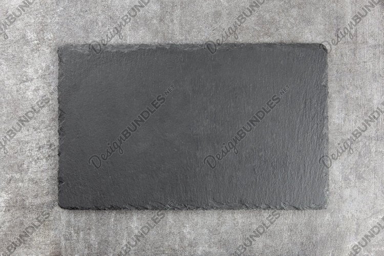 Natural black slate stone, gray concrete background. example image 1