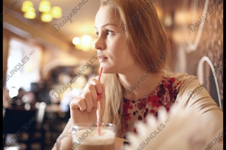 Girl is looking through the window in cafe