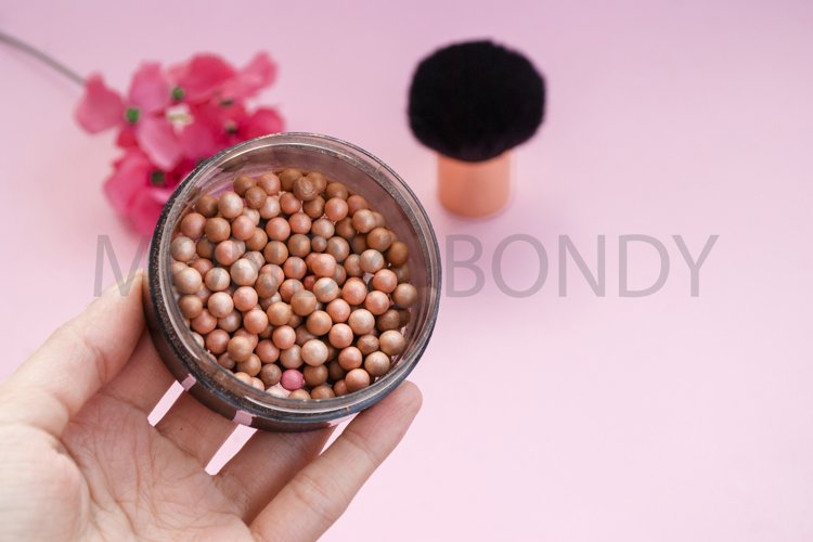 Cosmetic blush in spheres on a pink background. example image 1